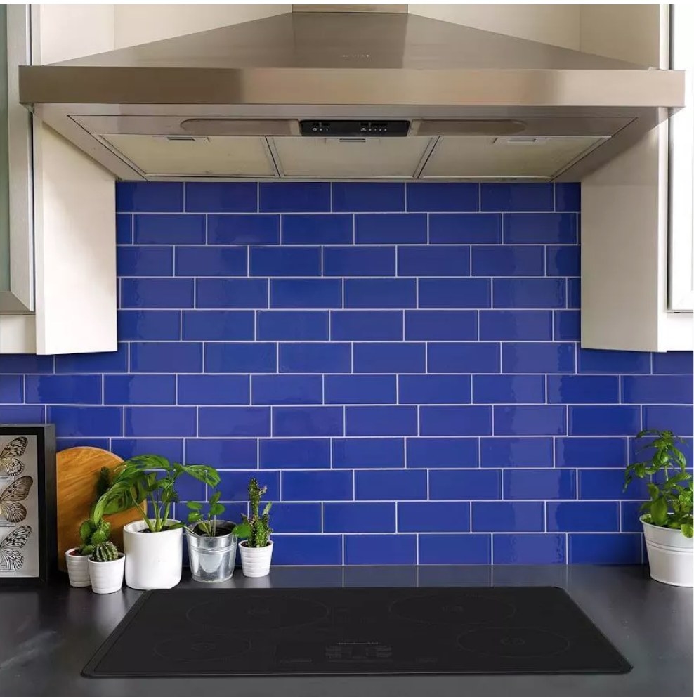 Blue, peel and stick, 3D backsplash tiles displayed over a stove 