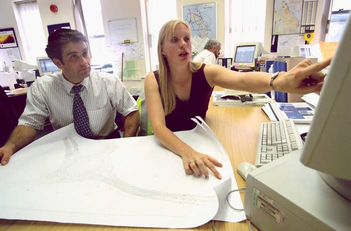 Architects working on computers with technical drawings