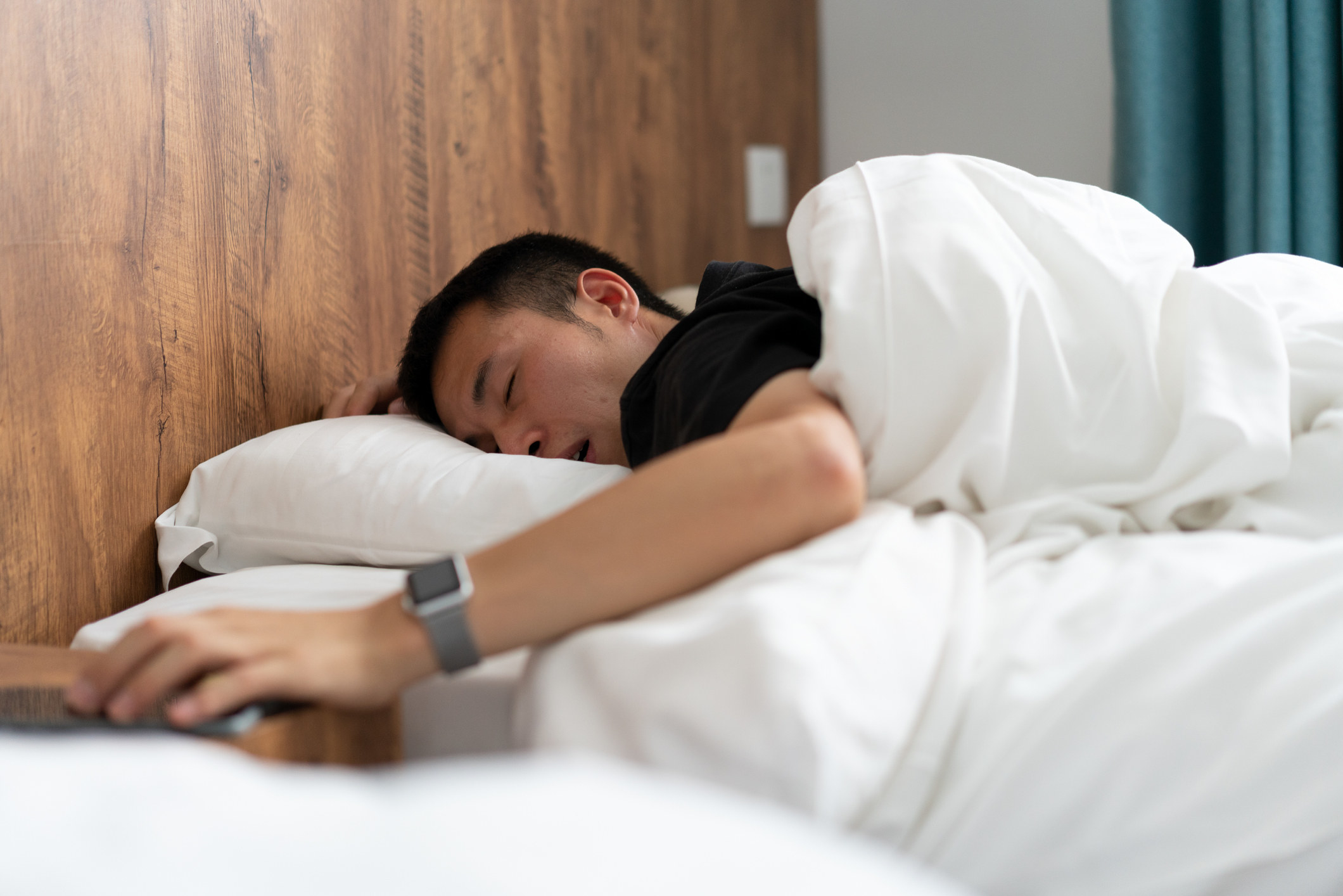 A guy asleep in bed