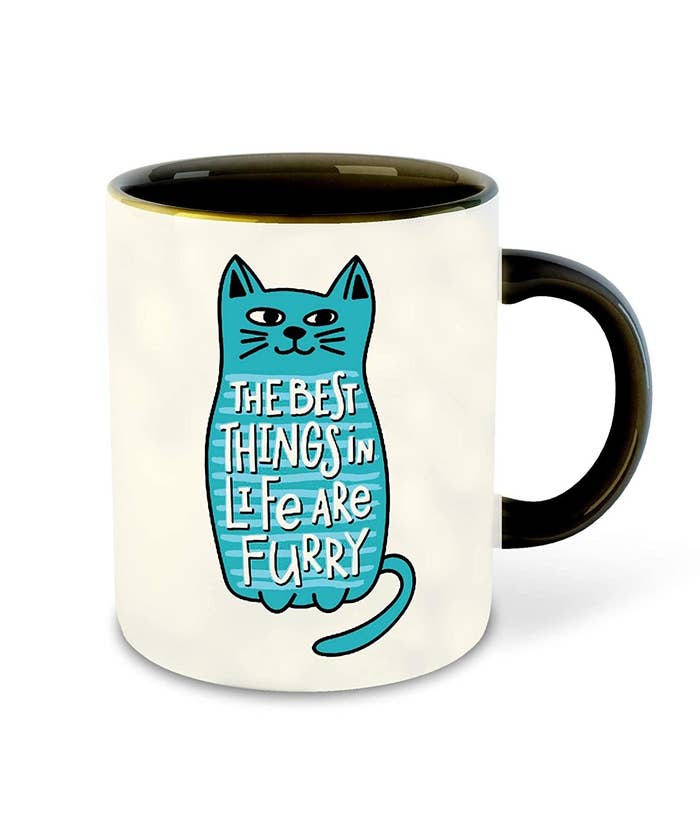 A white coffee mug with a blue cat and the words &#x27;The best things in life are furry&#x27;.