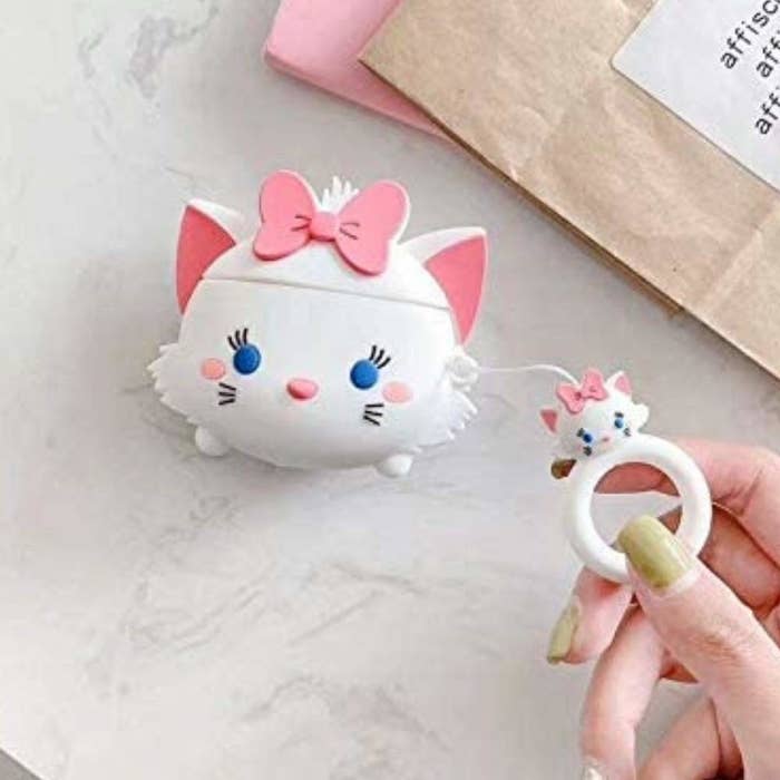 White cat EarPods case with pink bow and blue dot eyes with little keyring attached