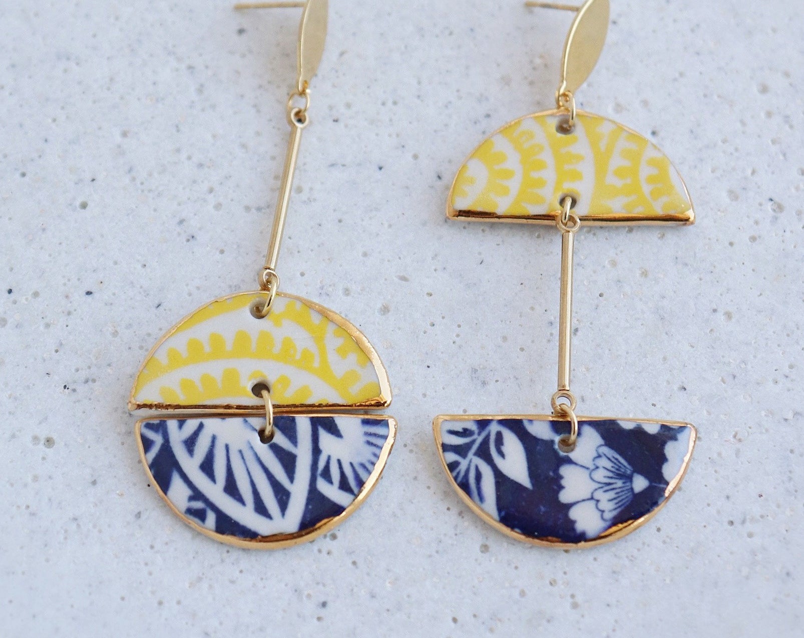 A pair of earrings on a plain background