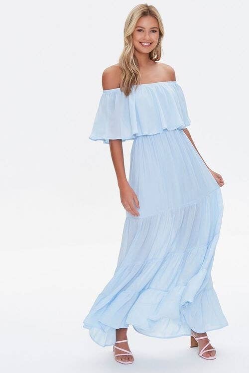 Model wearing baby blue dress with tiered skirt and ruffled top