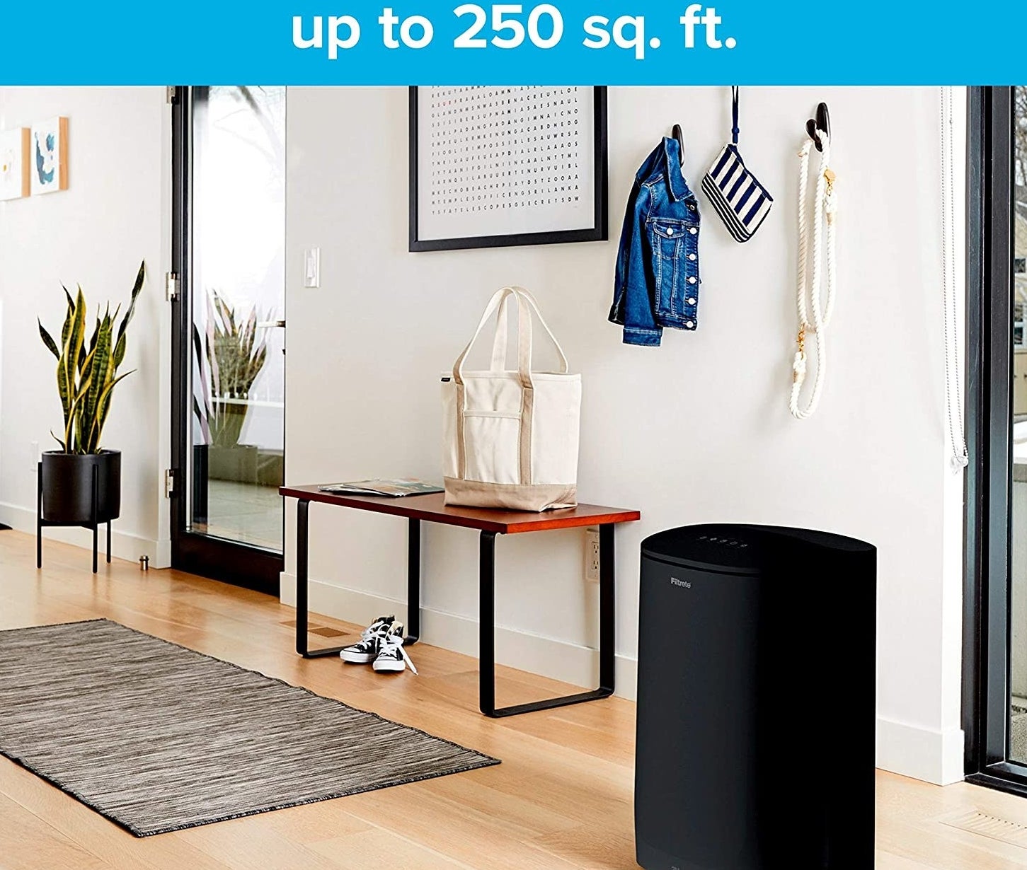 black air purifier styled in an entryway 