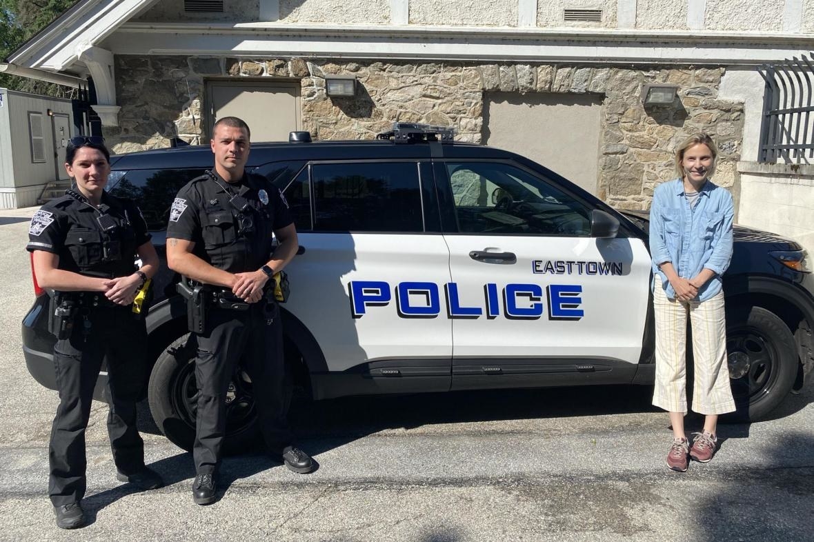 Journalist Laura Pullman, who visited Easttown, with two police officers of Easttown