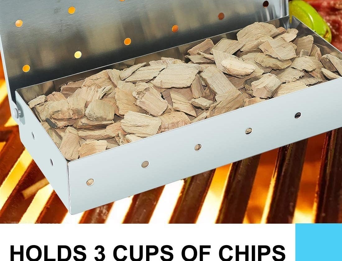 the box full of wood chips on a grill