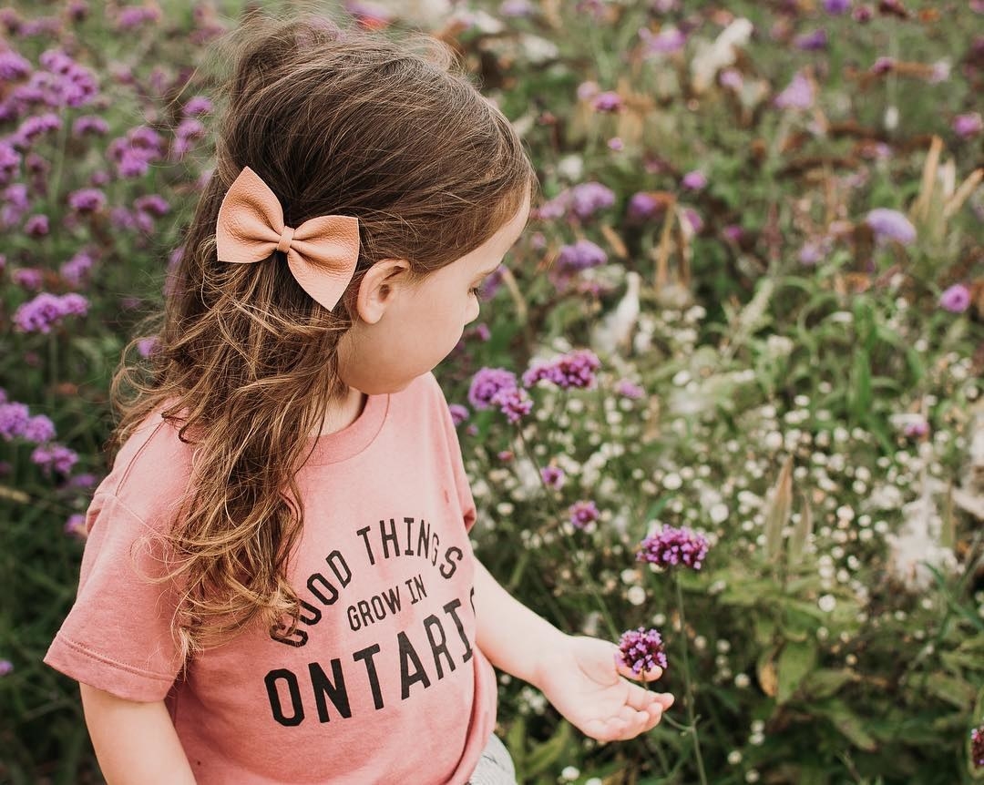 A child wearing a T-shirt that says good things grow in ontario