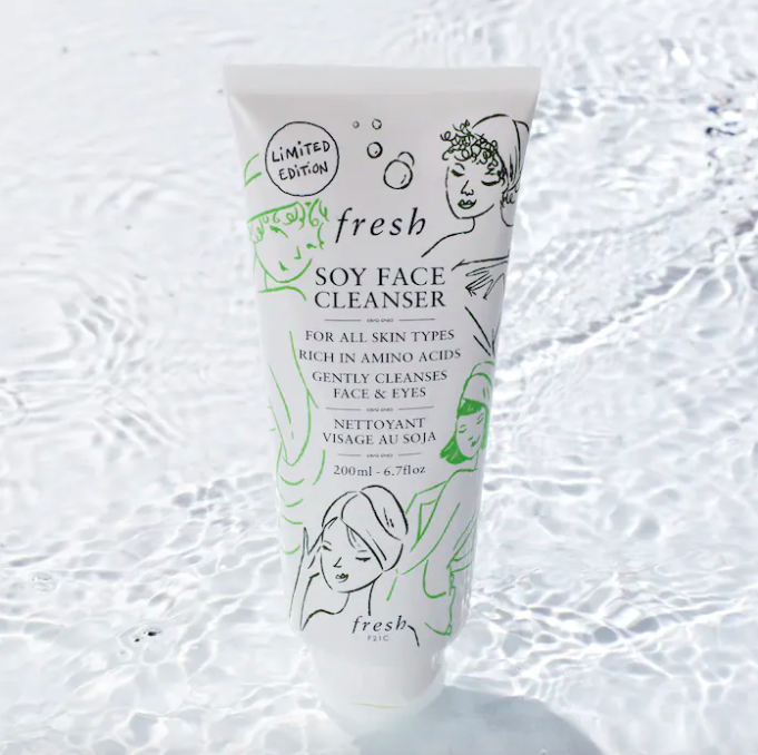A tube of the facial cleanser; it has doodles of people in towels on it