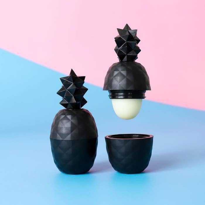A pineapple shaped lip balm on a colourful background