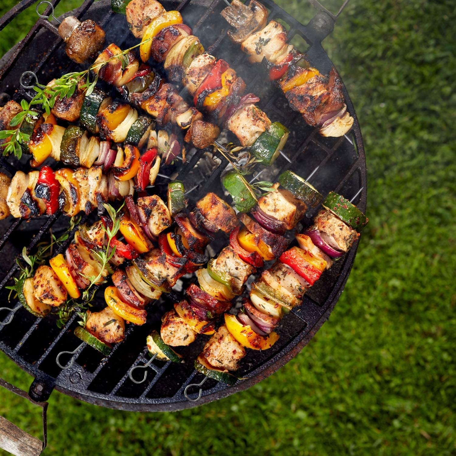 skewers with meat and veggies on a grill