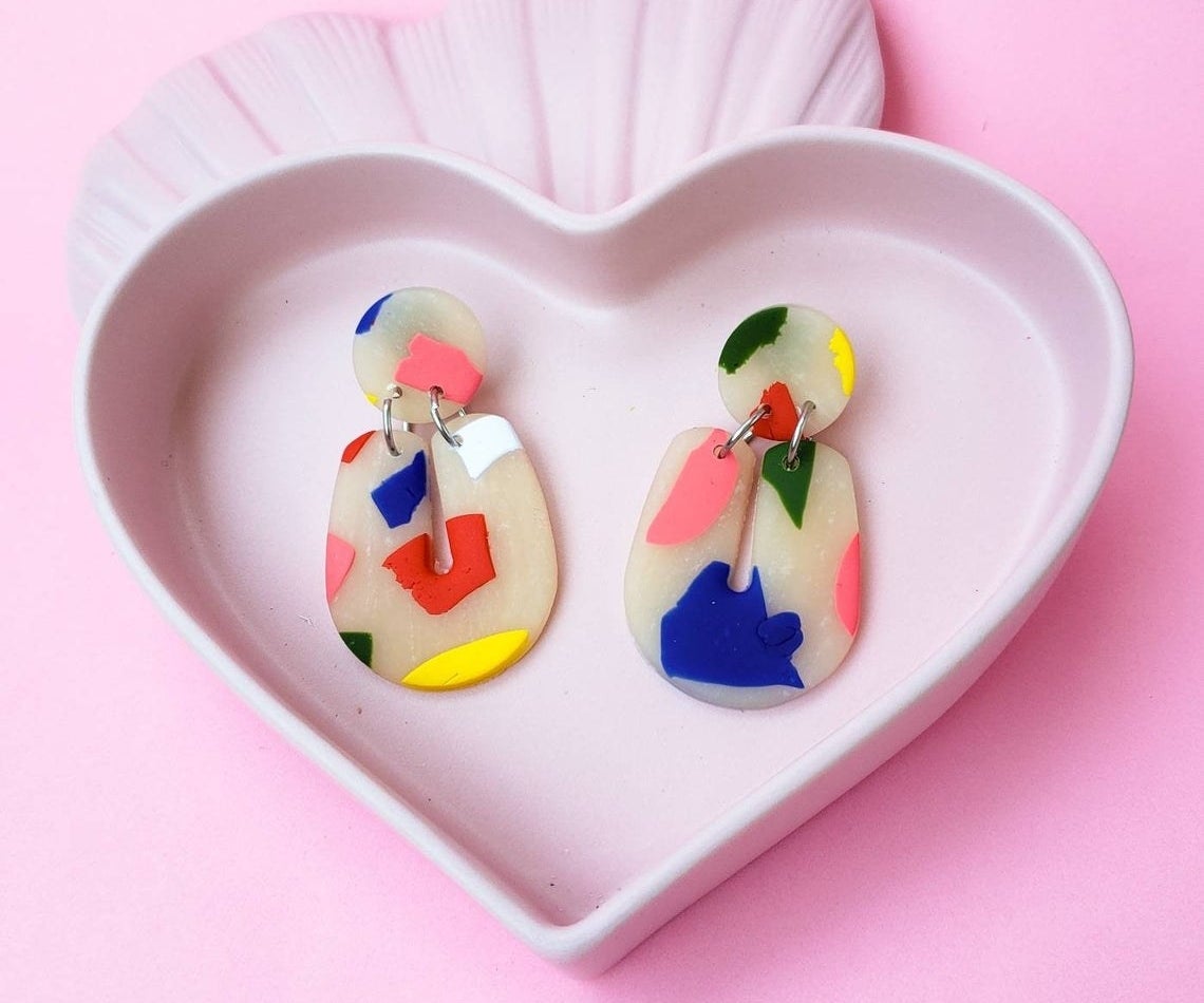 A pair of earrings in a small tray