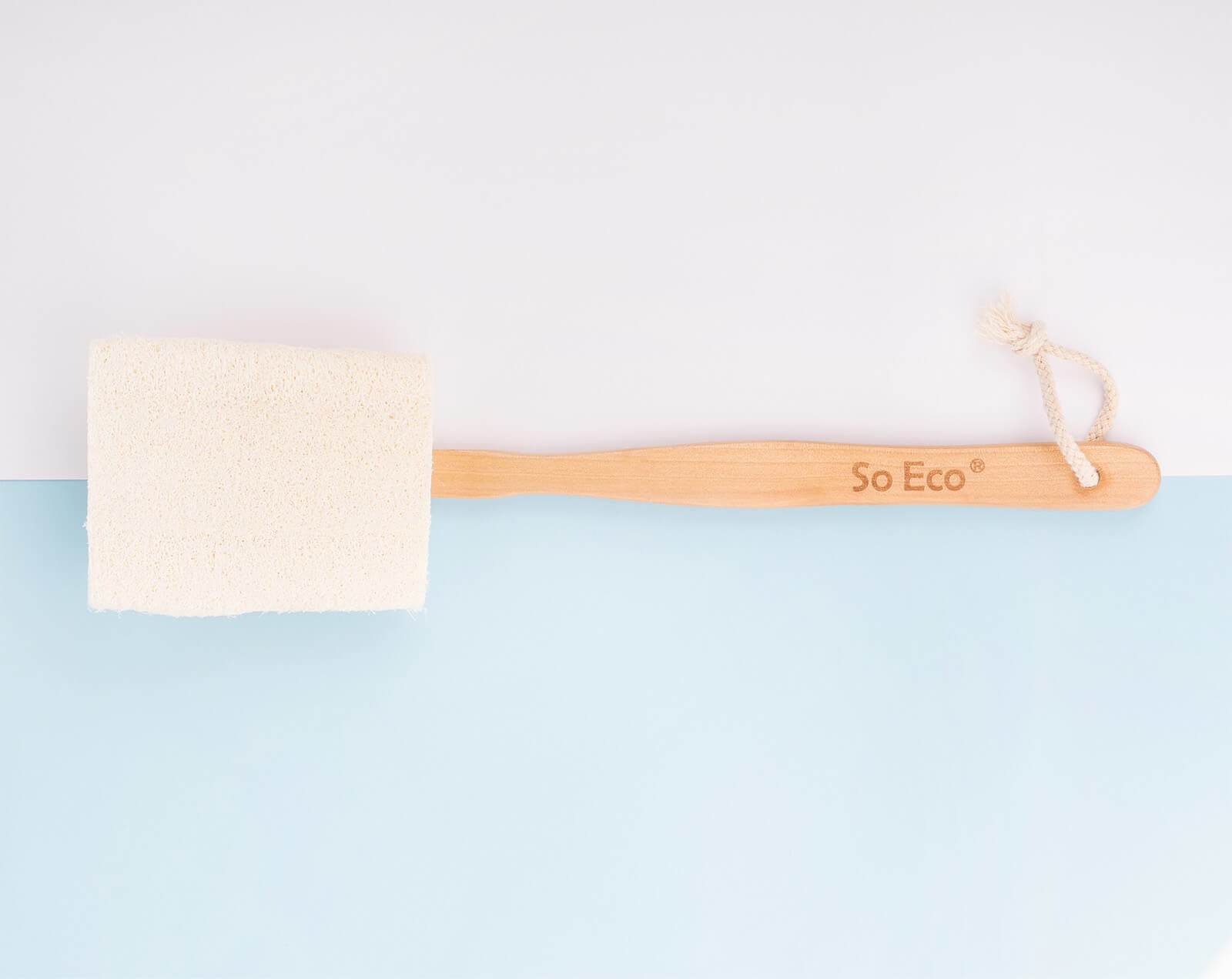 A loofah sponge attached to a long wooden handle