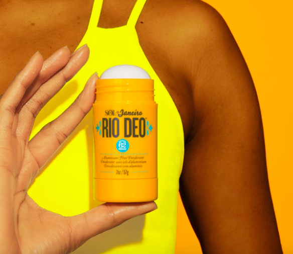 A person holding up the deodorant
