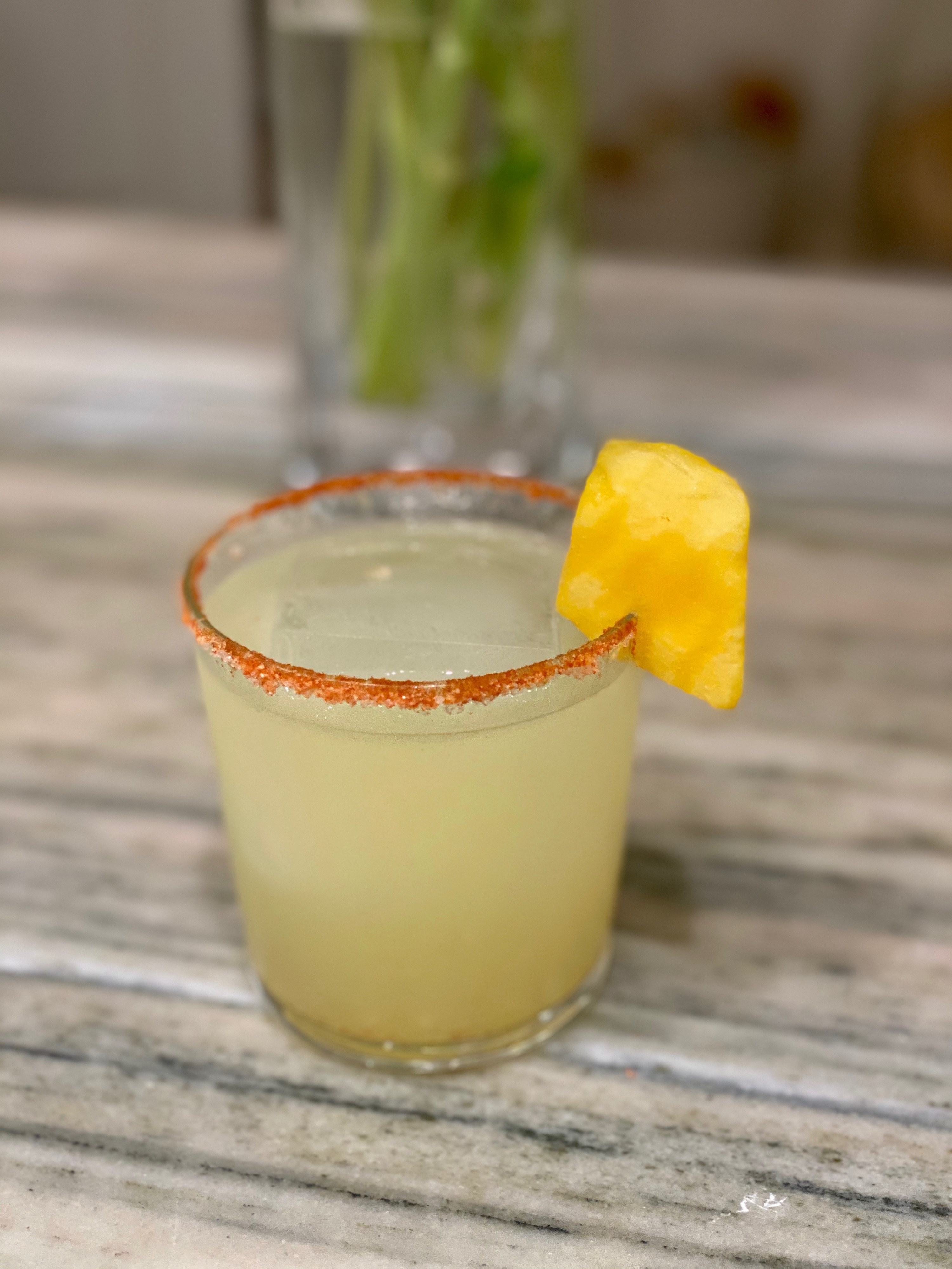 A margarita with a salted rim and mango.