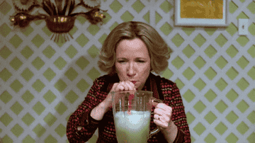 Debra Jo Rupp drinking a margarita from a blender.