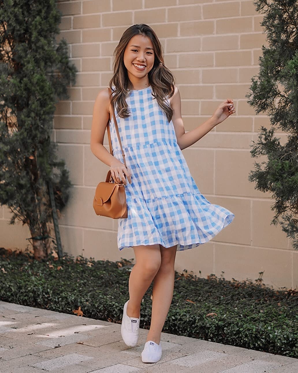 A model in the above-the-knee light blue and white dress