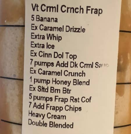 A closeup of the order label, which includes modifications like &quot;add five bananas, extra caramel drizzle, extra whip, extra cinnamon dolce toping, heavy cream, double blended, and more.