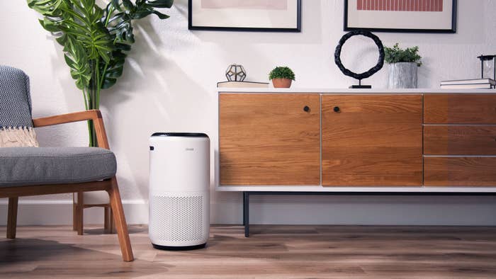 An air purifier sitting on the floor in a room
