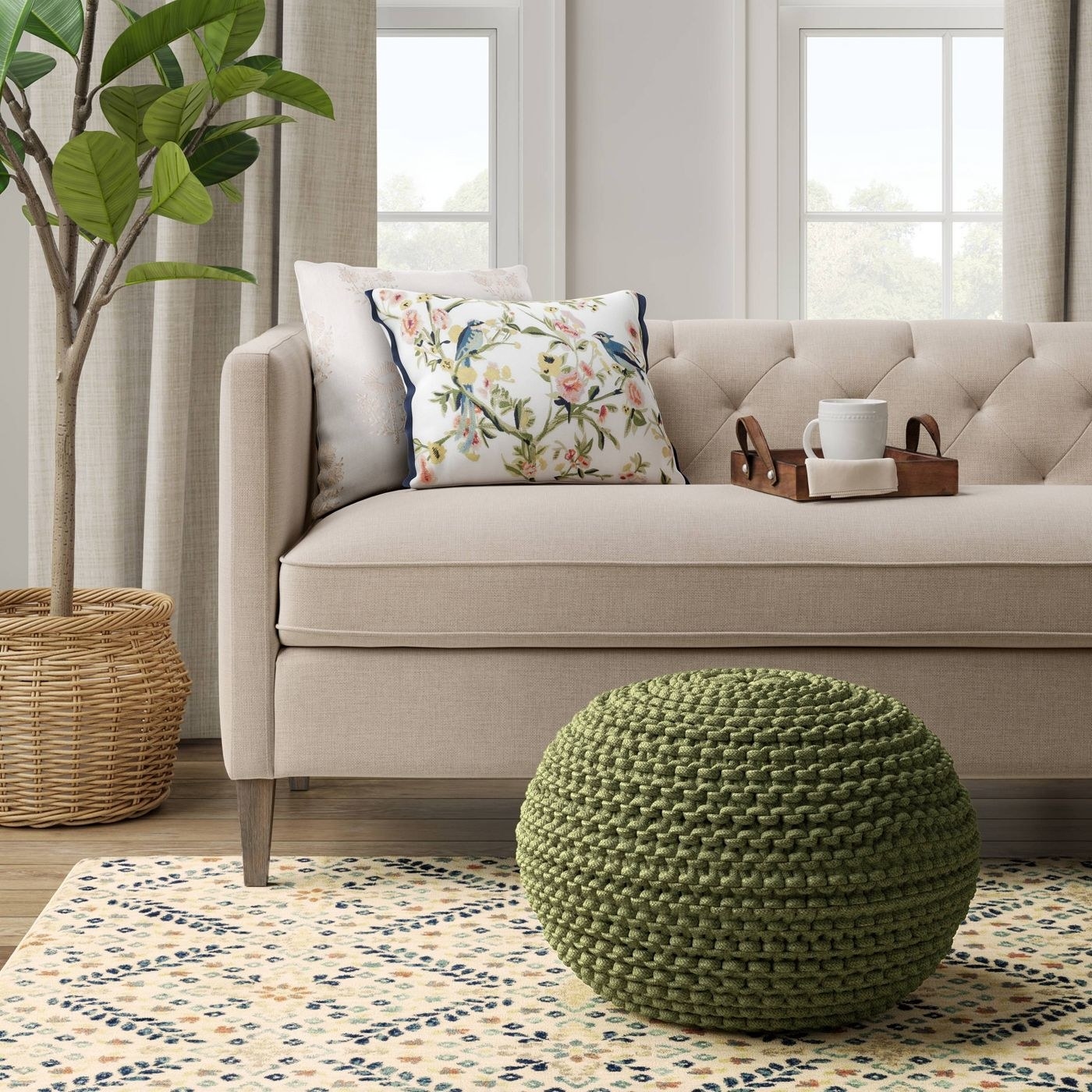 A green knit pouf in front of a sofa