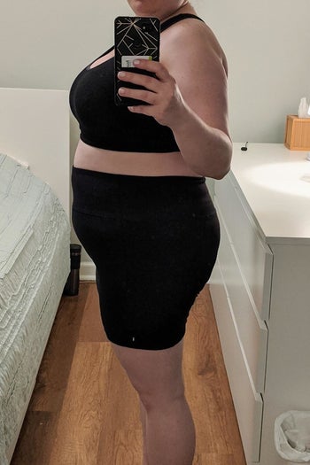 a reviewer mirror selfie of someone wearing a sports bra and the biker shorts