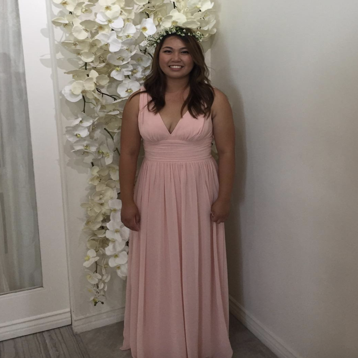 reviewer wearing a pink V-neck dress