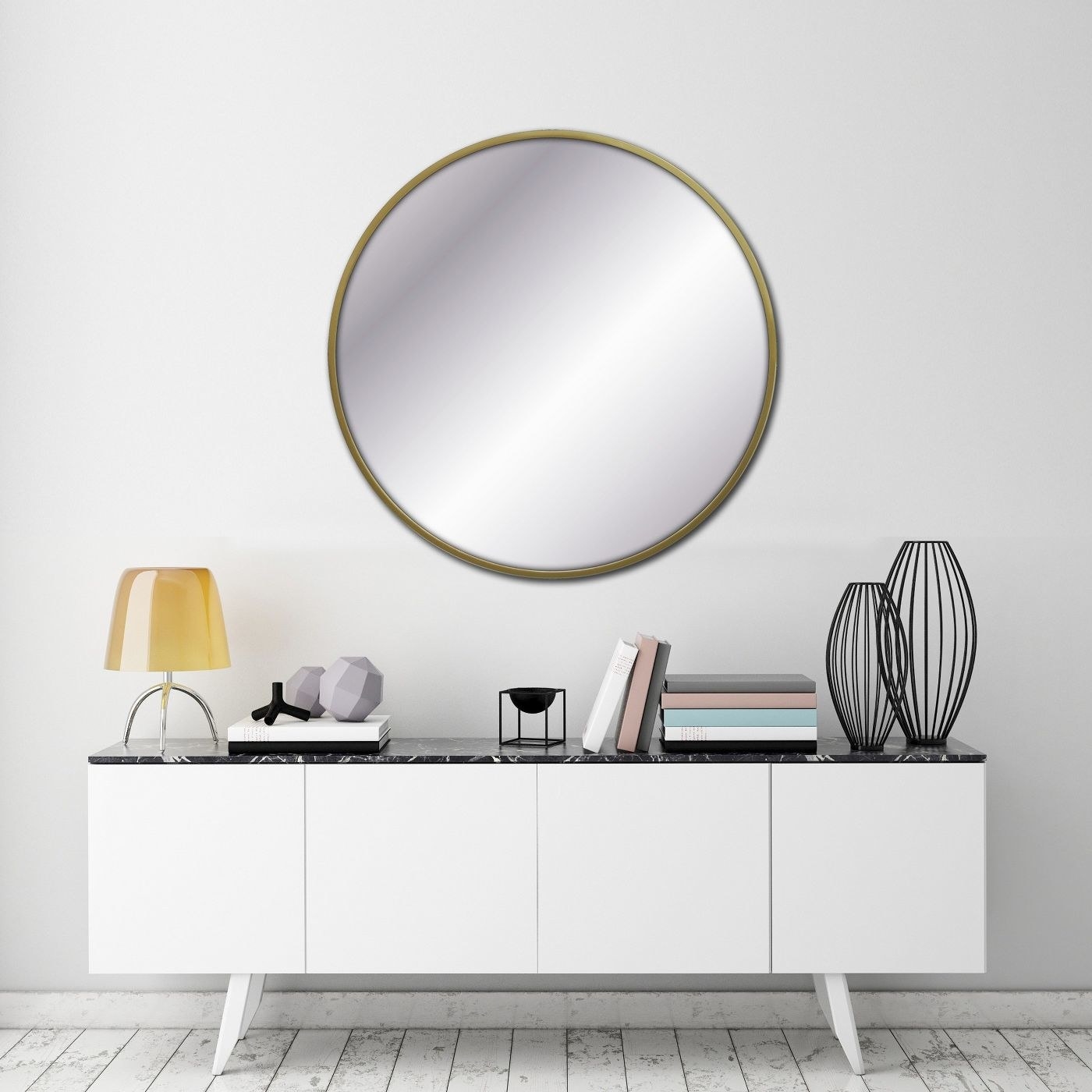 A round decorative wall mirror hanging above a console table 
