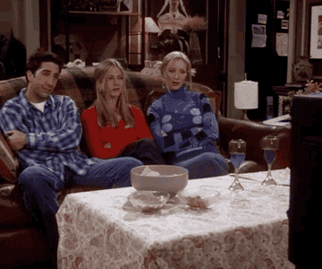 Cast of Friends laughing and watching TV