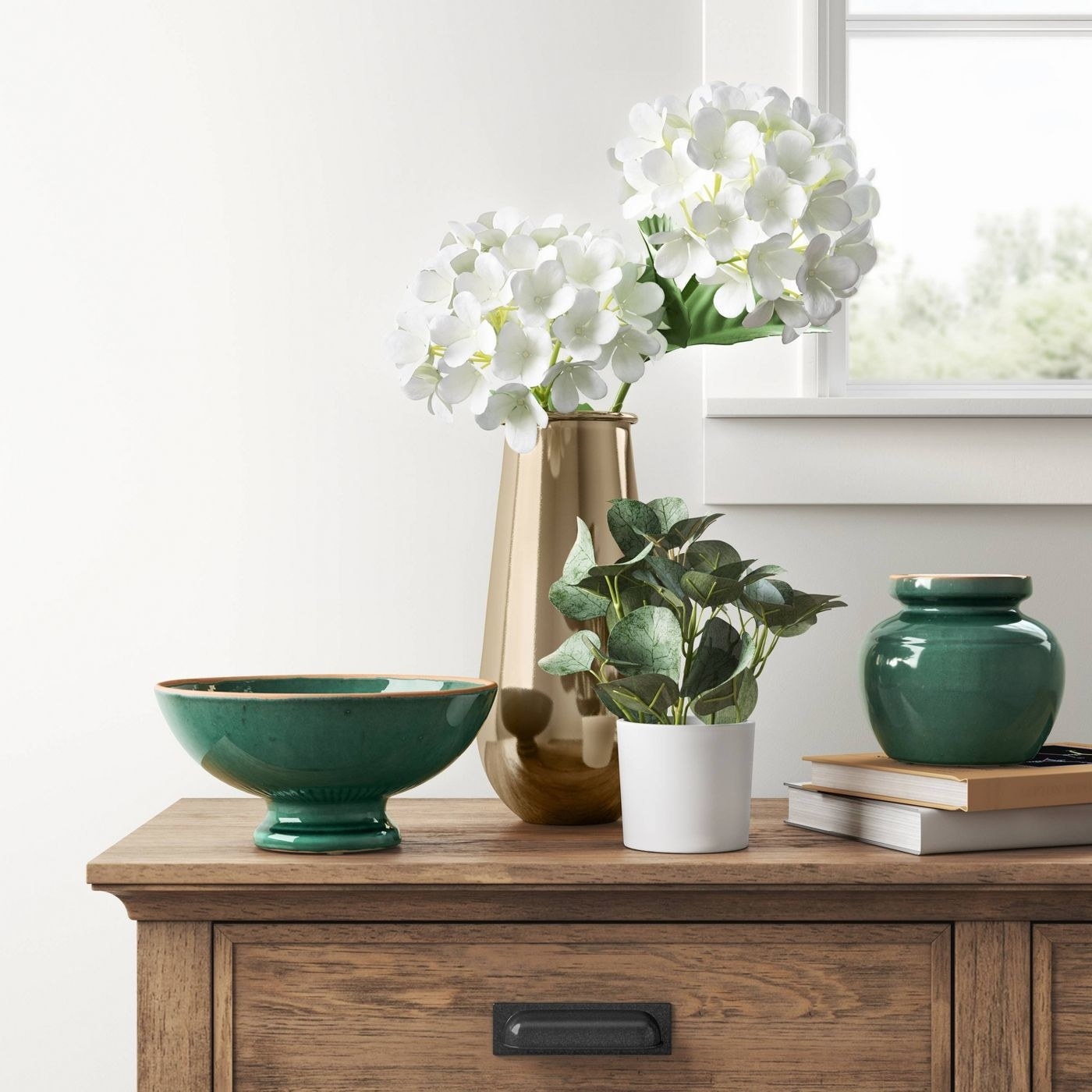 An artificial eucalyptus potted plant on a console table 