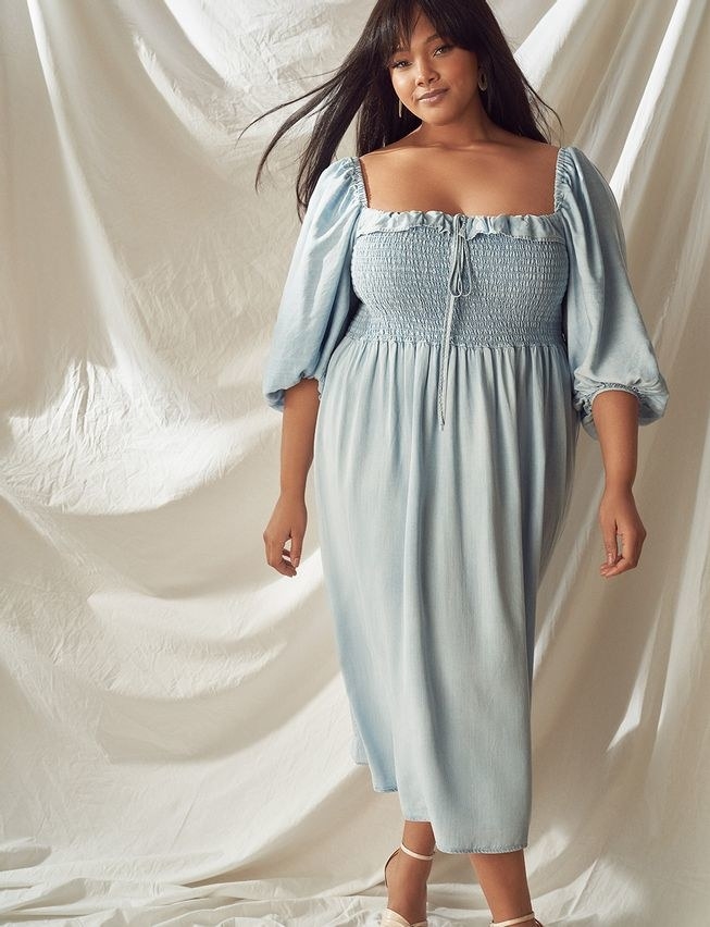 model wearing the pale chambray midi dress with three-quarter puff sleeves