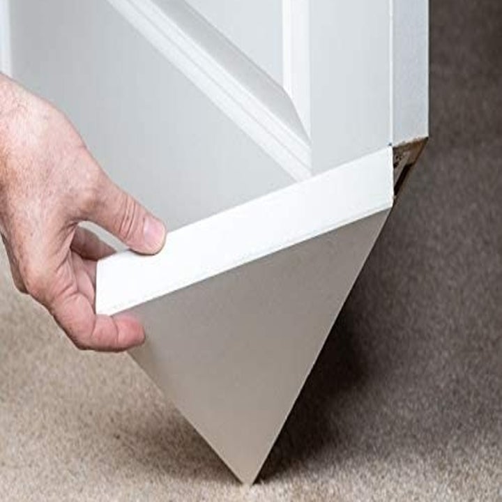 The triangular hinged area on the door being pulled up by a hand 