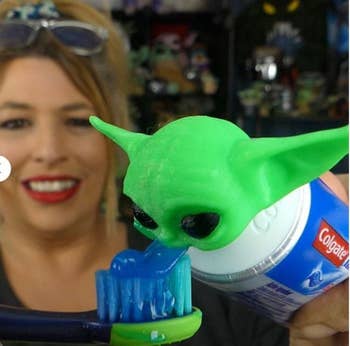 A model with a tube of toothpaste topped with a Baby Yoda head that dispenses toothpaste out of its mouth