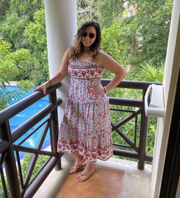 reviewer wearing the strapless red and white dress 