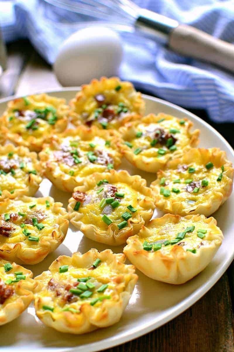 Mini quiche bites with chives, cheese, and bacon.