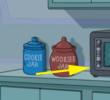 Microwave sitting next to a cookie jar and a Wookiee jar