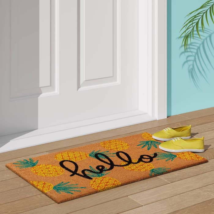 doormat with pineapple print and "hello" written on it