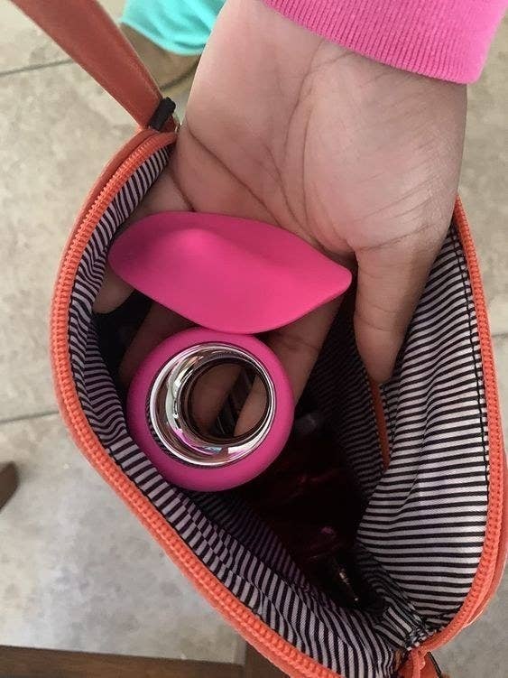 A reviewer demonstrates that they've snuck the product out in their purse, the implication being they're gonna get up to some public play later