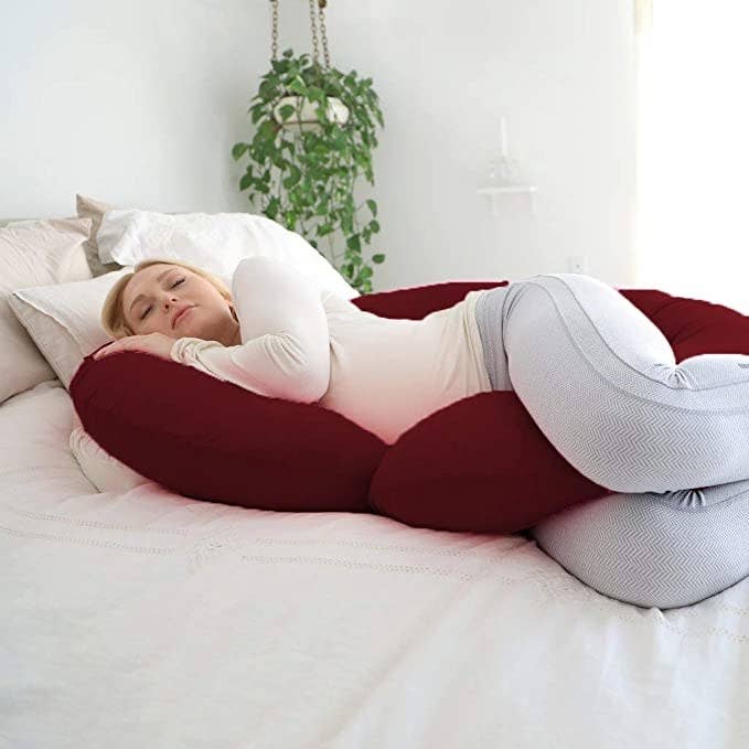 Woman sleeping with the C-shaped body pillow.