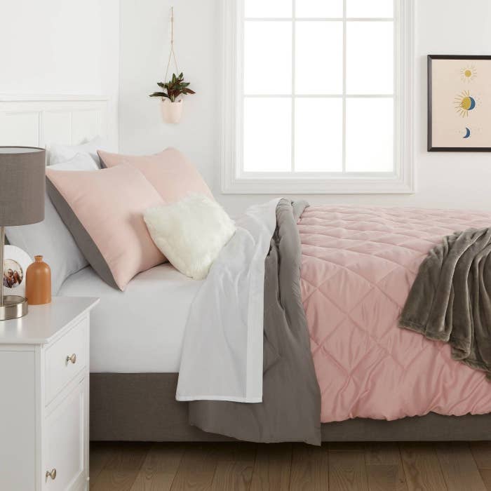 A microfiber decorative bedding set in pink and gray