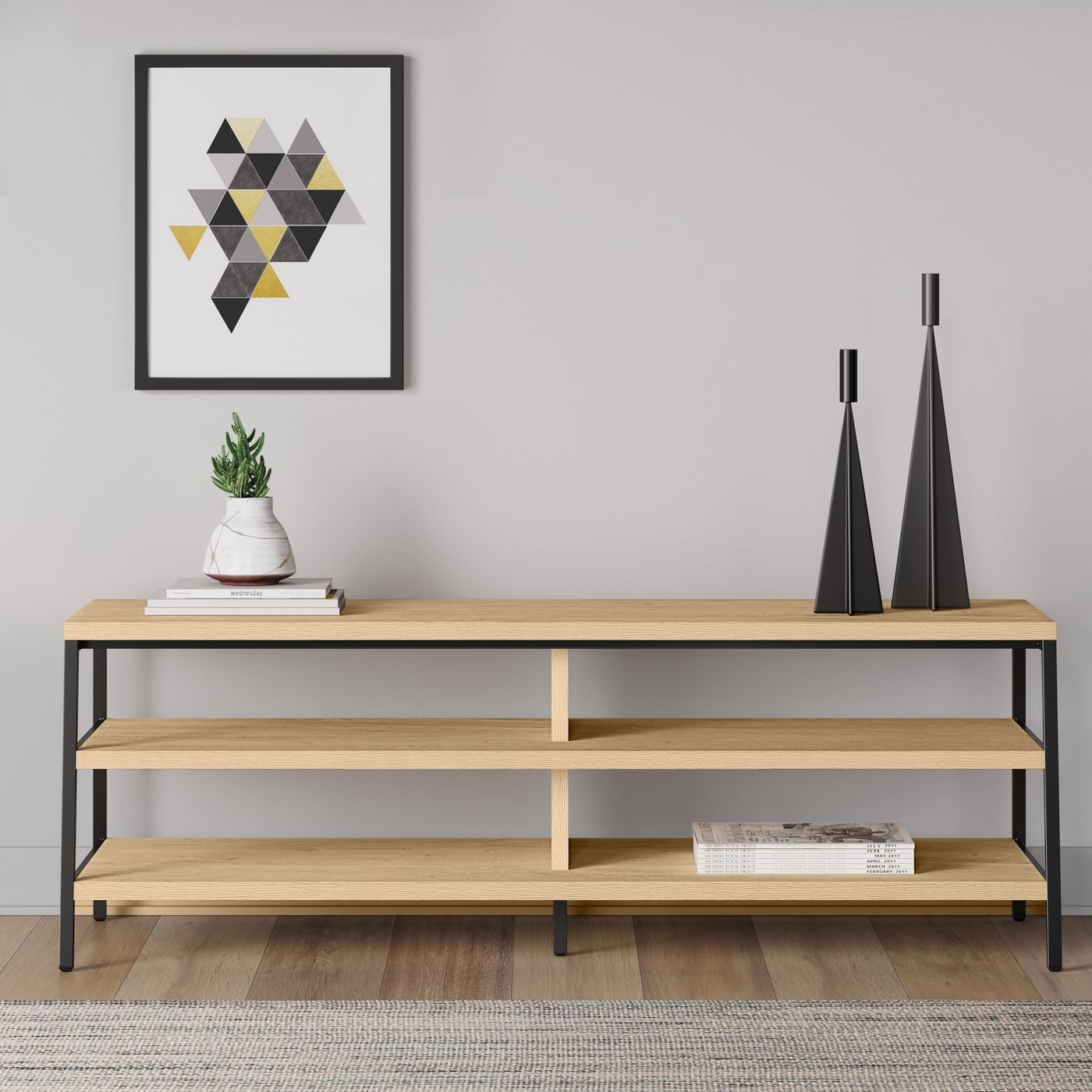 A natural wood TV stand with metal legs