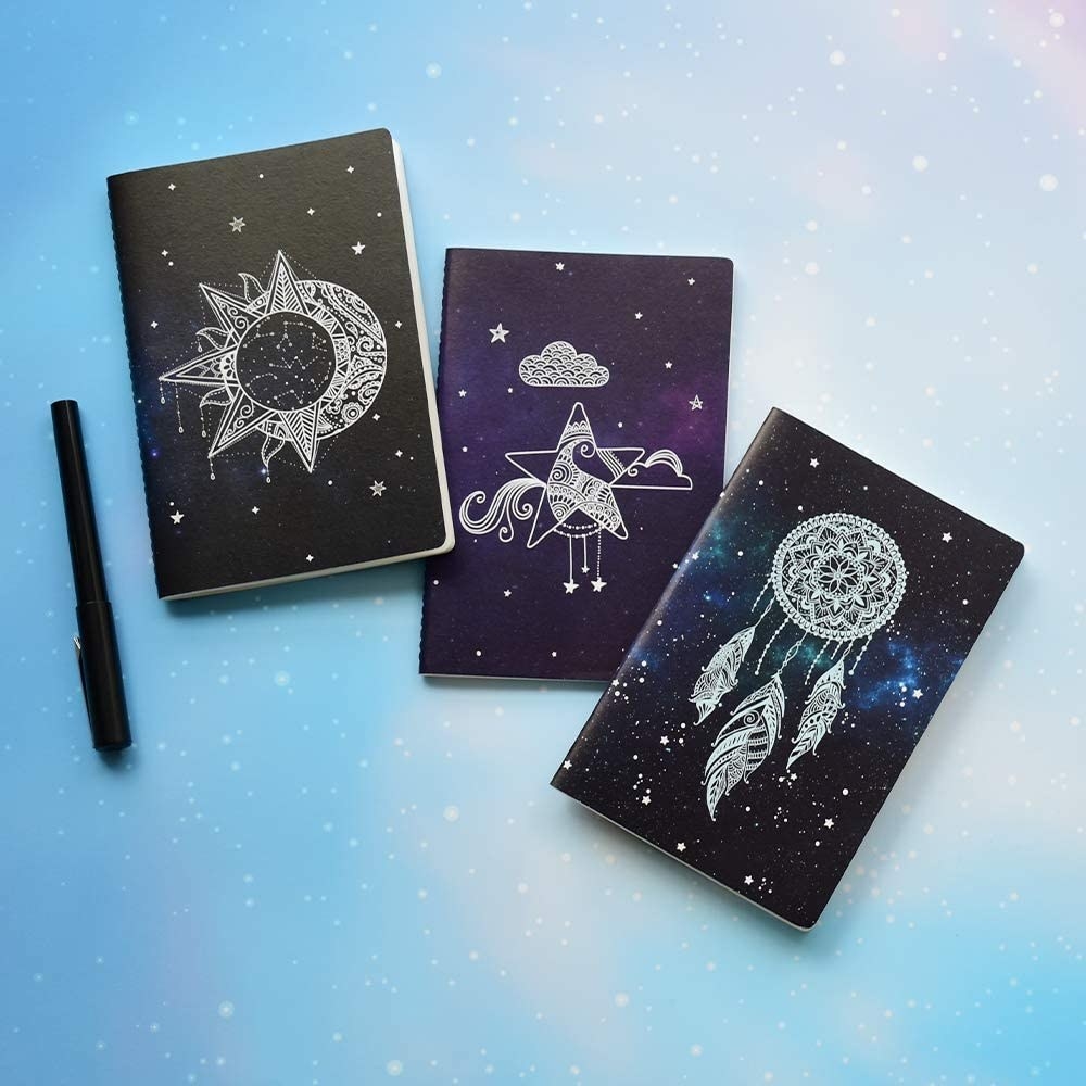Three galaxy-themed notebooks