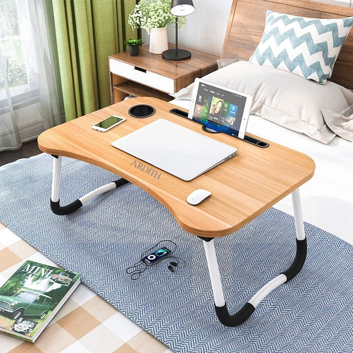 A foldable laptop desk on a bed 