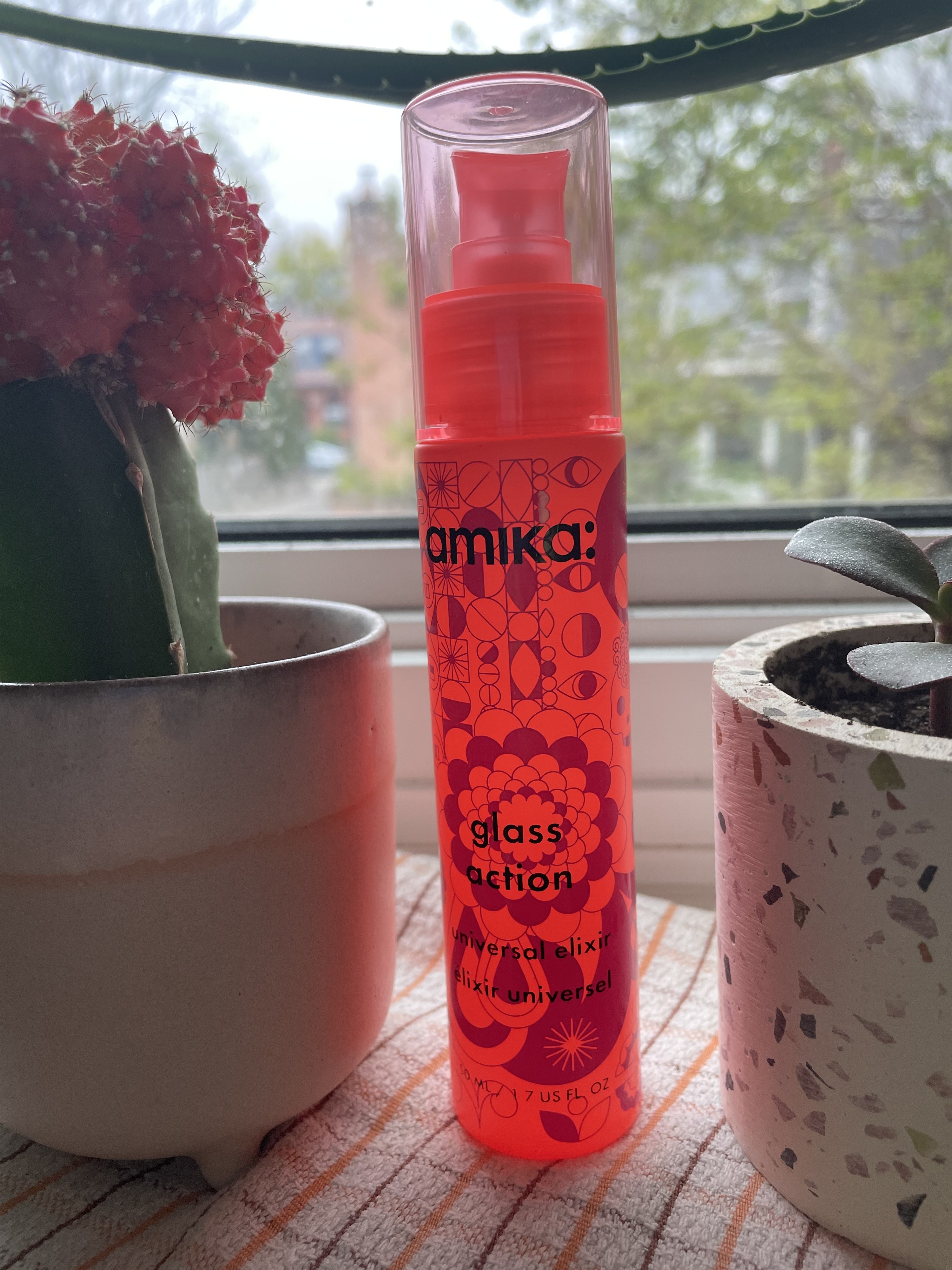A bottle of Amika&#x27;s glass action universal elixir 