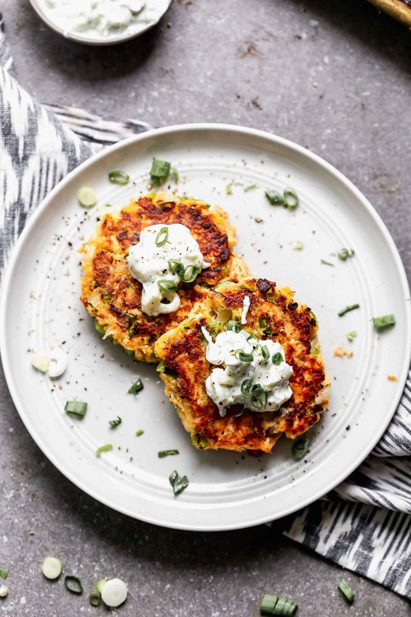 Two salmon cakes topped with crème fraîche. 