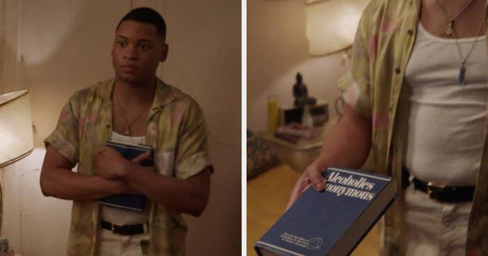 Damon holding an alcoholics anonymous book