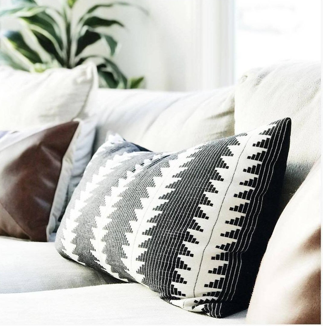 black and white patterned pillow on a couch