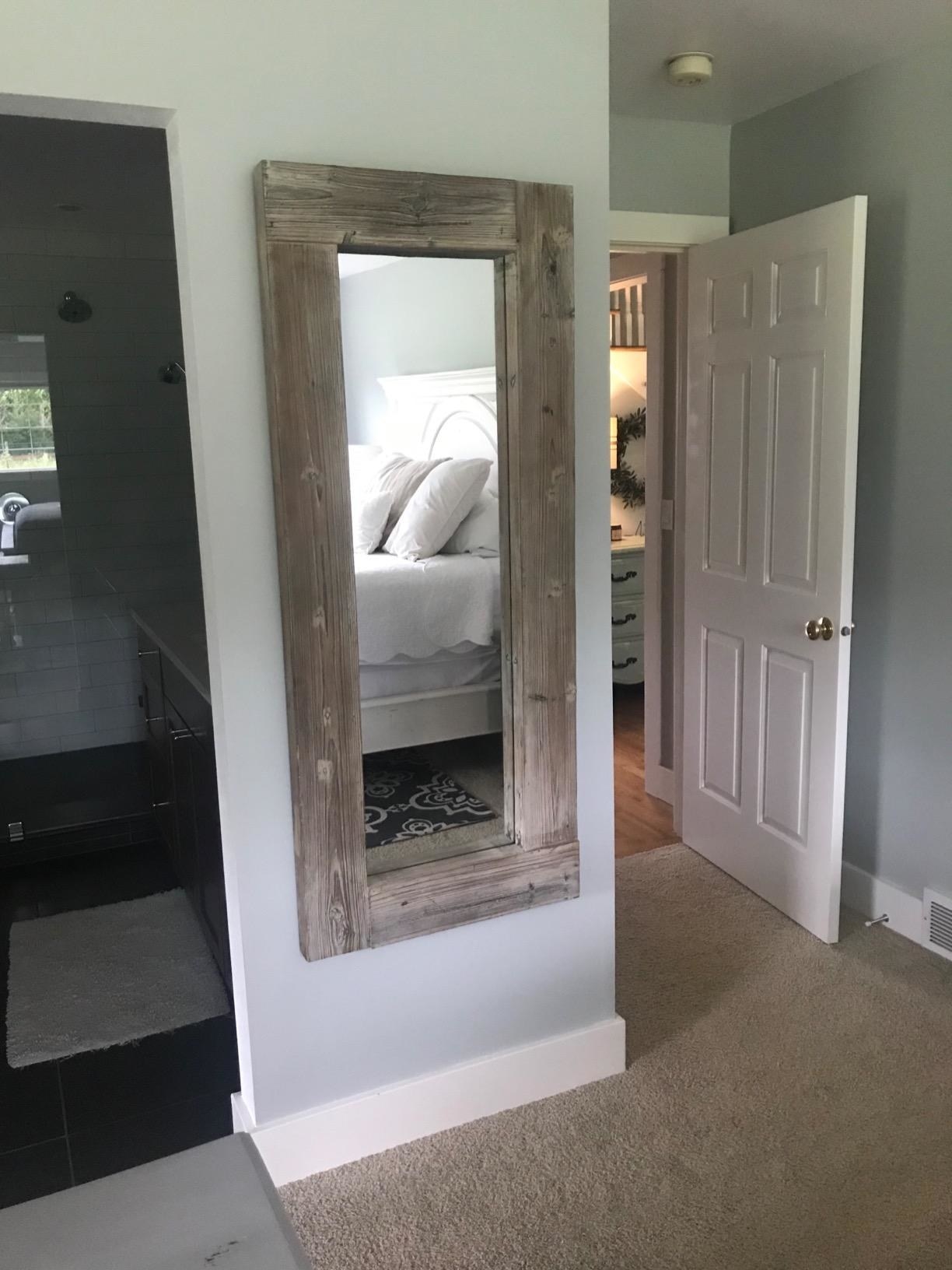 reviewer image of the barnyard designs full length mirror mounted to a bedroom wall