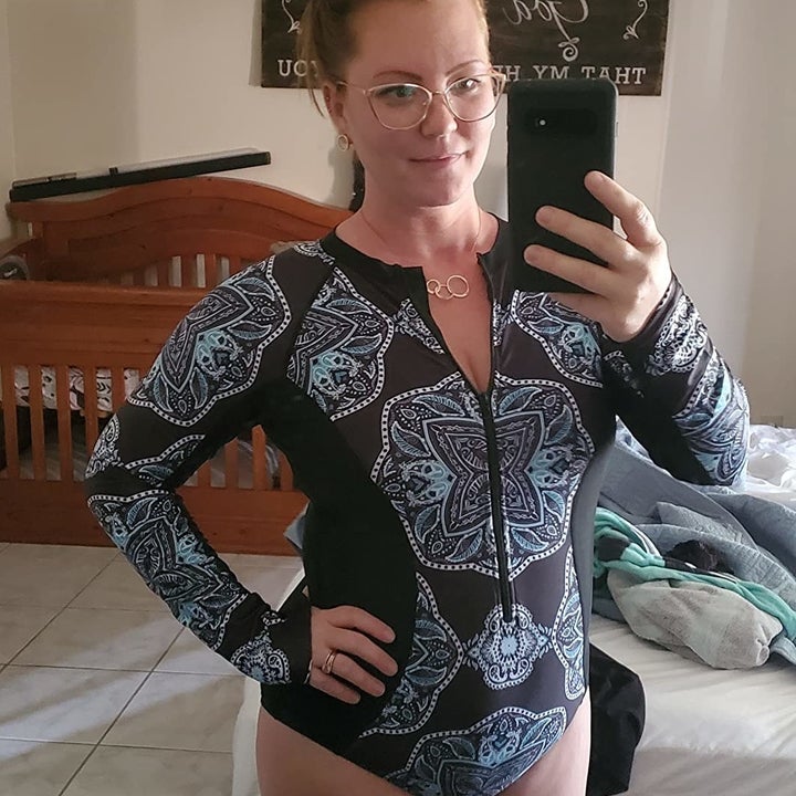 reviewer photo wearing rash guard in black and blue