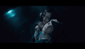 Bellatrix holds Hermione&#x27;s head with one hand and places a knife across her neck with the other