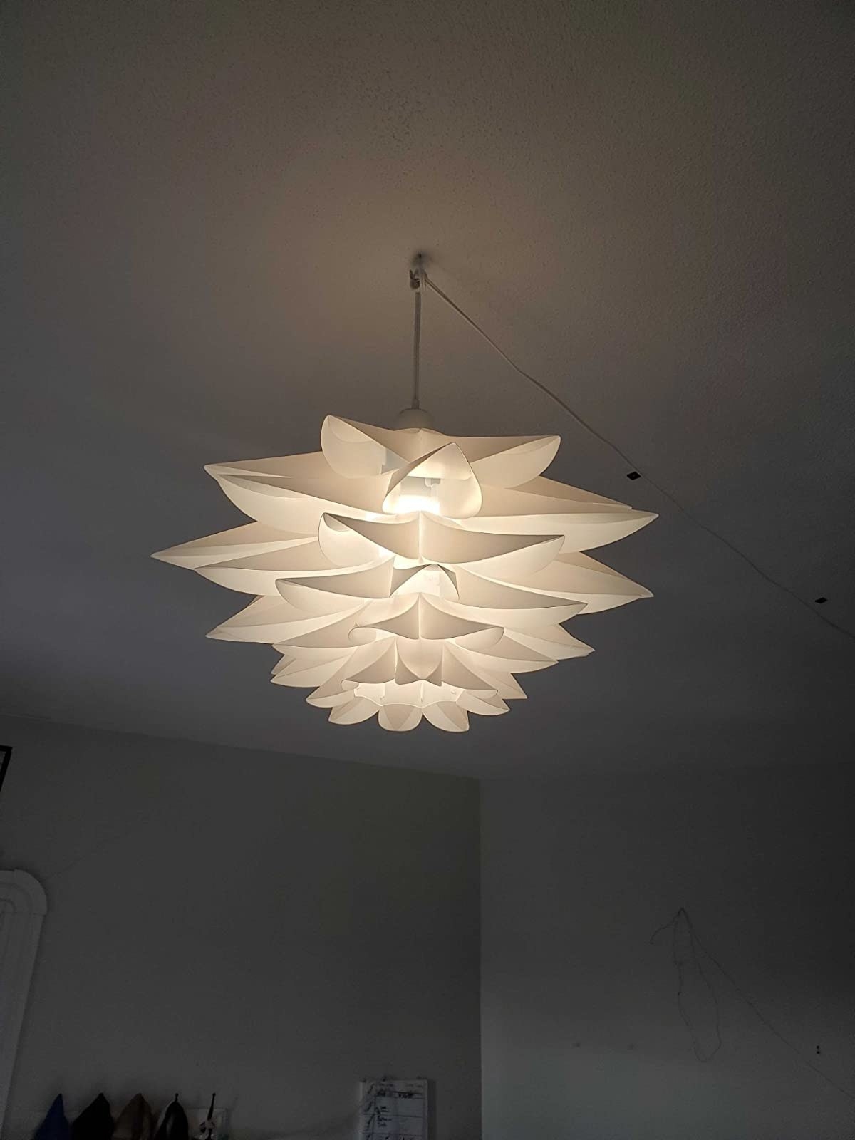 reviewer image of the lotus pendant light hanging from the ceiling