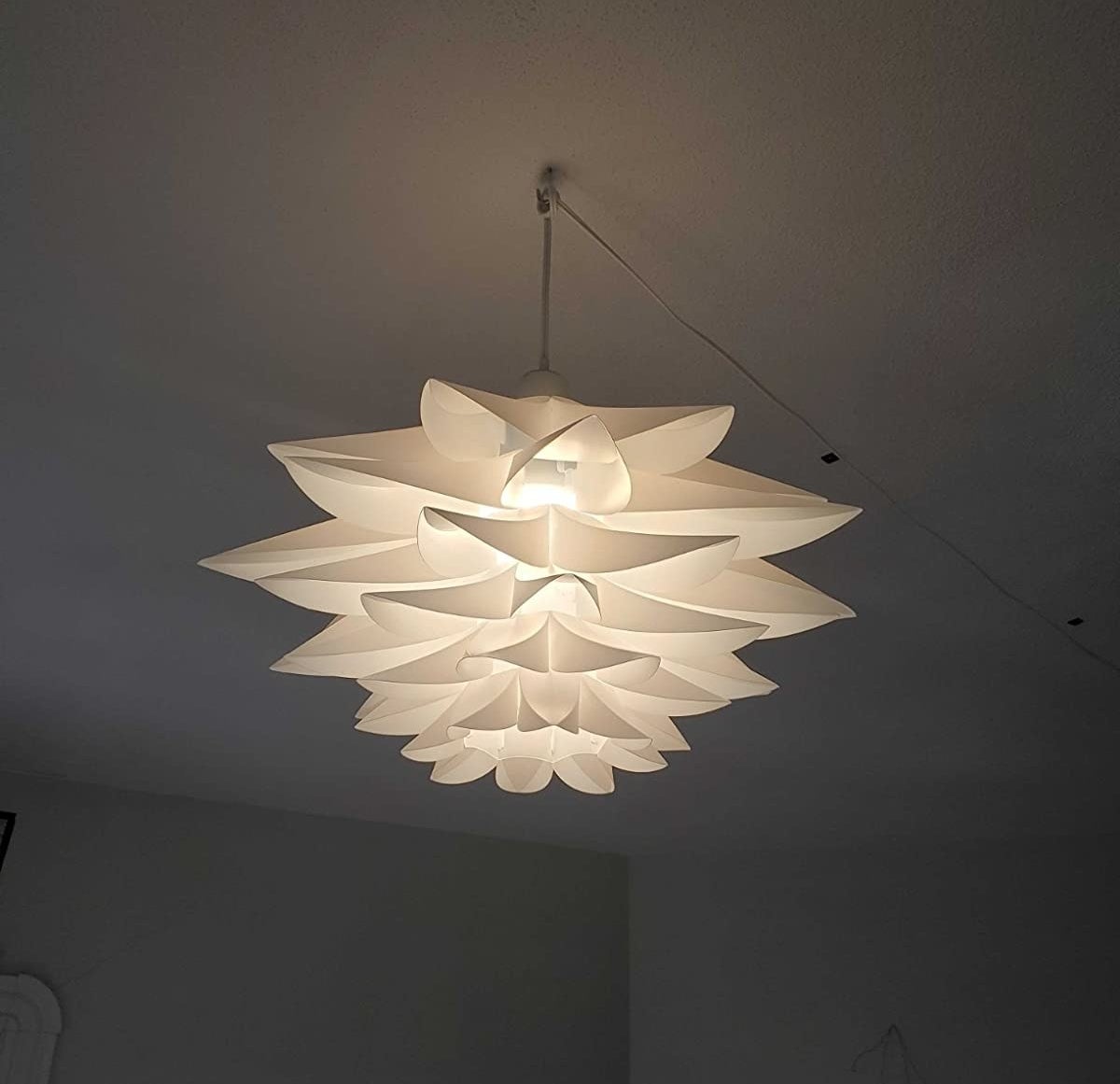 reviewer image of the lotus pendant light hanging from the ceiling